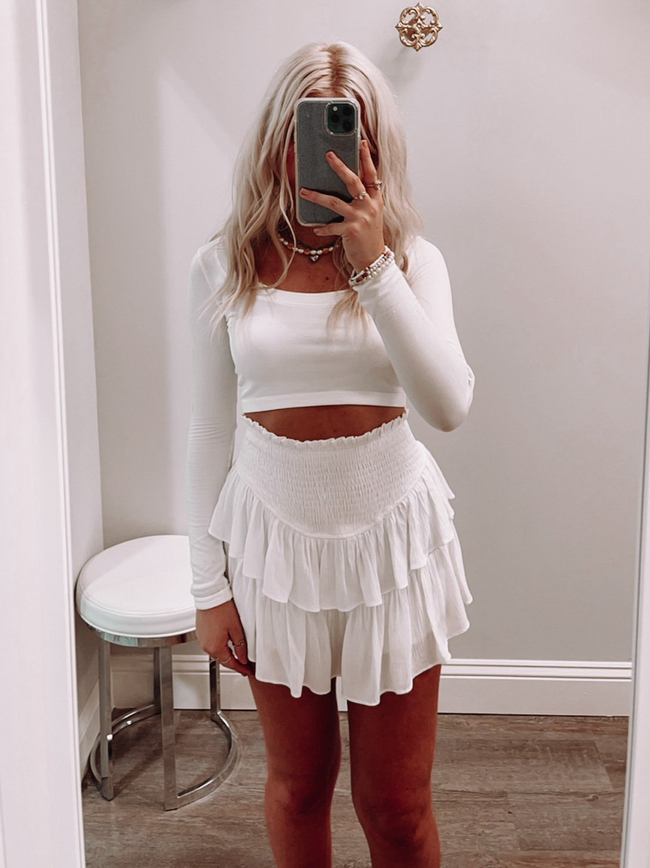 White tiered ruffle mini skirt; stylish summer outfit.
