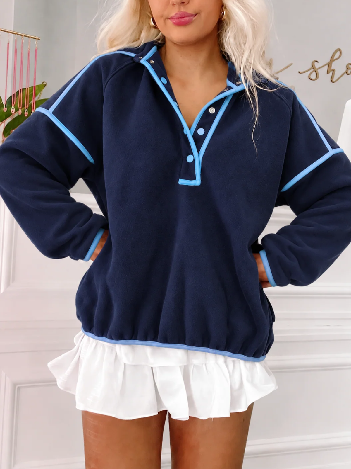 Front view of the Sassy Shortcake Ivy League Pullover snapped closed, showing the stand-up collar, light blue snaps, and piping.