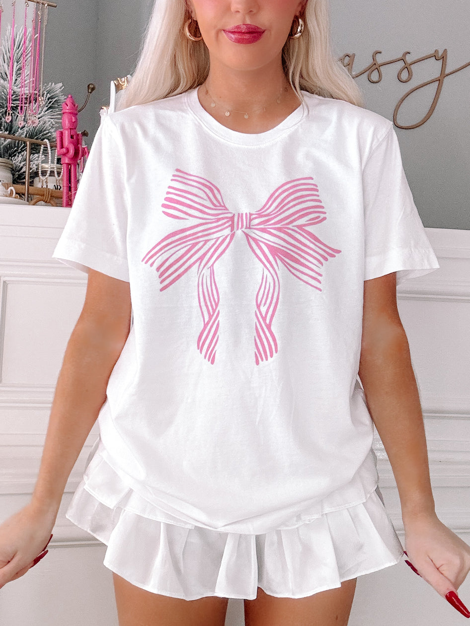 Lexi Bow Tee in pink: White tee with pink striped bow graphic.
