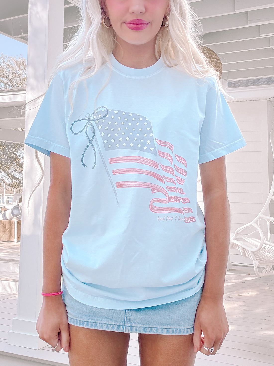 Sky blue oversized Liberty Tee with bold American flag graphic on front