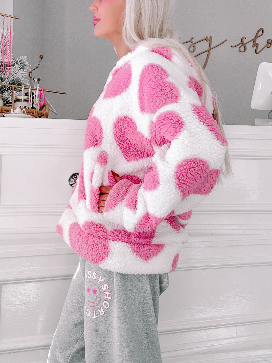 Pink and white heart-print sherpa jacket, soft and cozy.
