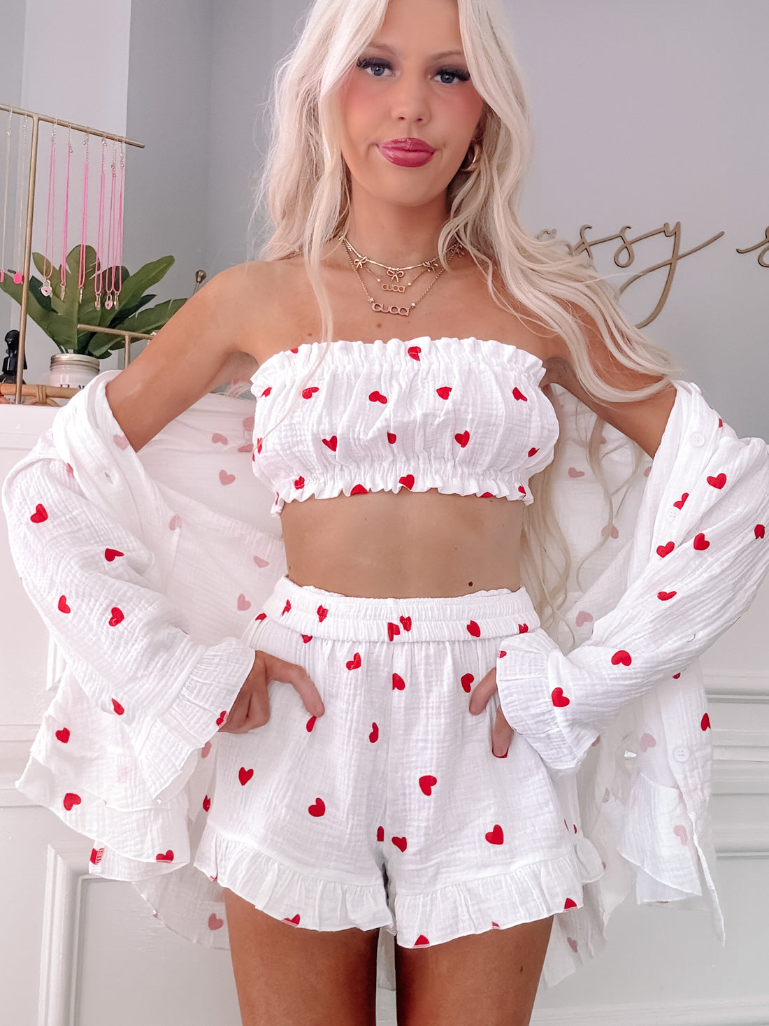 White heart-print lounge set: ruffled shorts and cropped top with matching open-front shirt.

