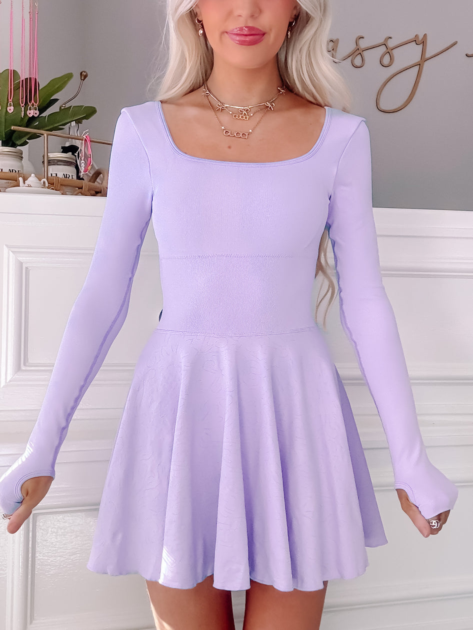 Lilac tennis dress with long sleeves and skater skirt.

