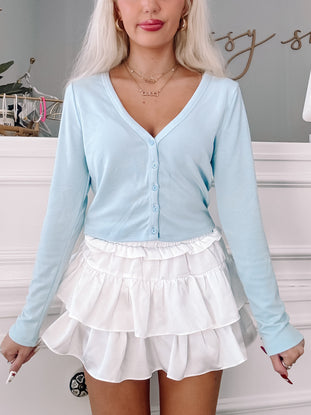 Light blue button-down Meleah top with long sleeves.
