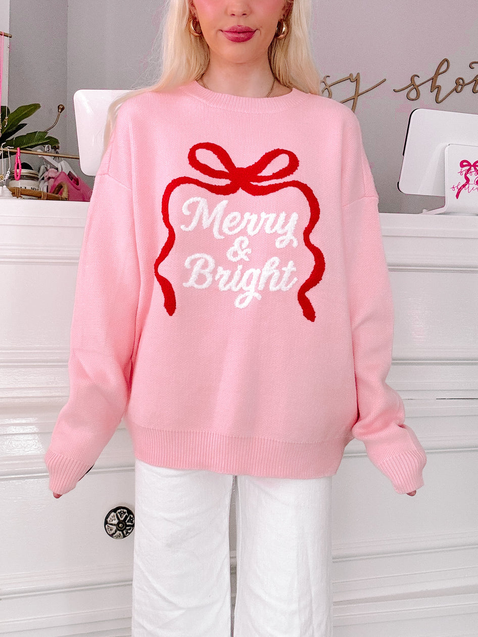 girl wearing a pink sweater with 'Merry & Bright' design from sassy shortcake
