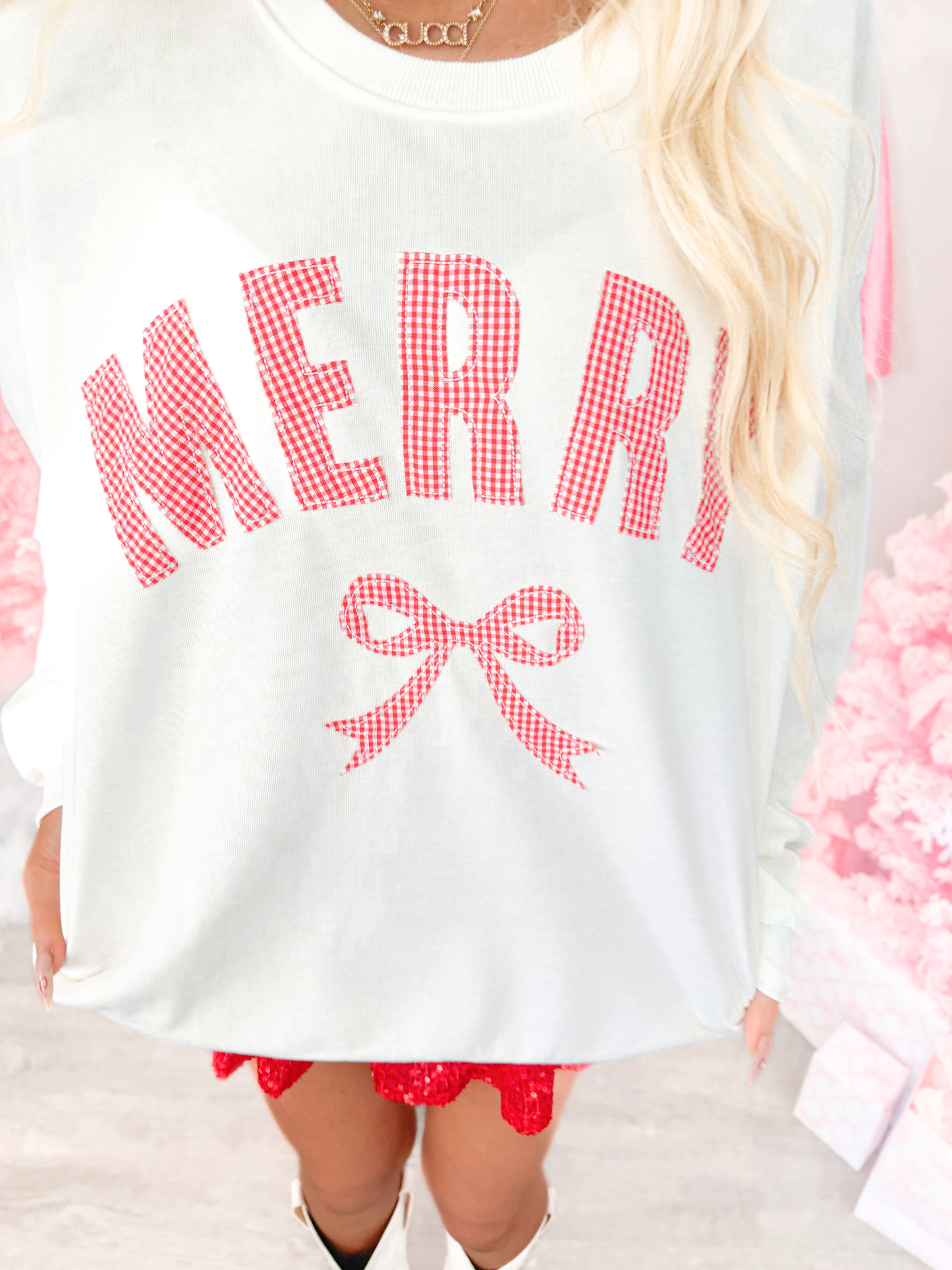 White sweatshirt with red 'MERRY' text and bow graphic from Sassy Shortcake
