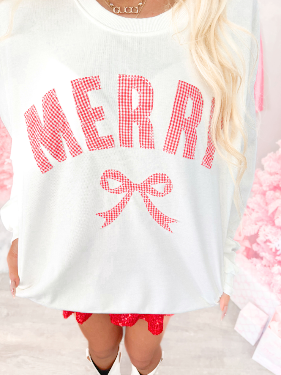White sweatshirt with red 'MERRY' text and bow graphic from Sassy Shortcake