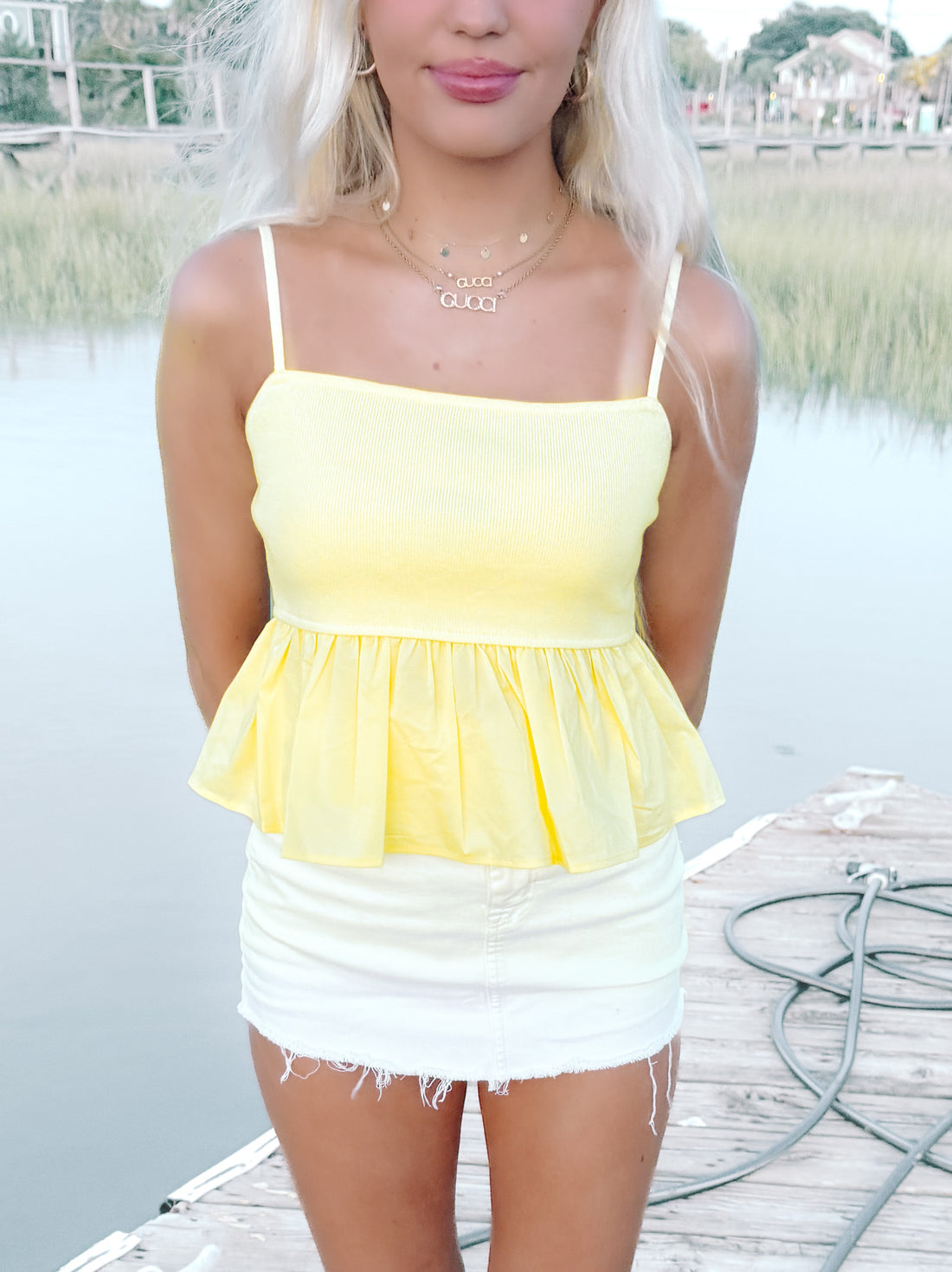 Model wearing yellow flutter sleeve Millie top with white skirt