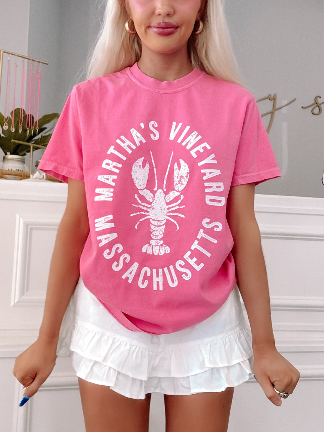 Model wearing pink Martha’s Vineyard tee with white lobster graphic.