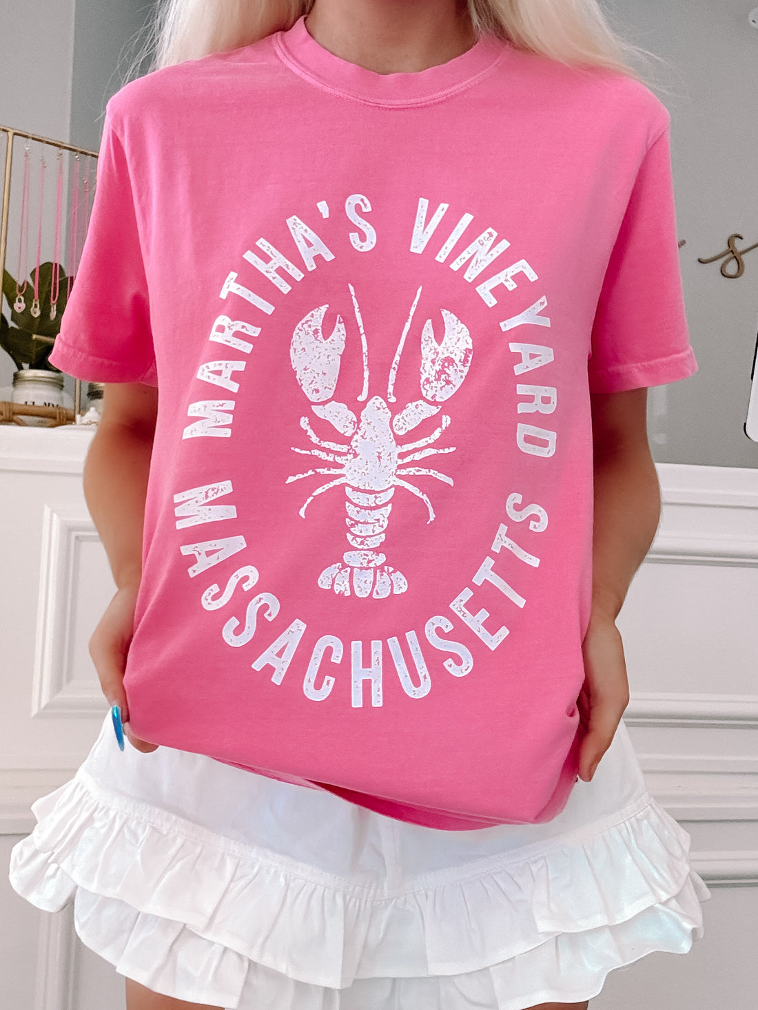 Oversized pink tee styled casually with coastal graphic print.