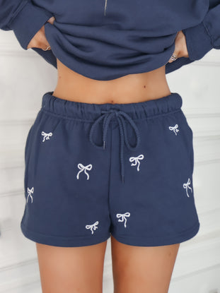 close up view of navy bow embroidered shorts 