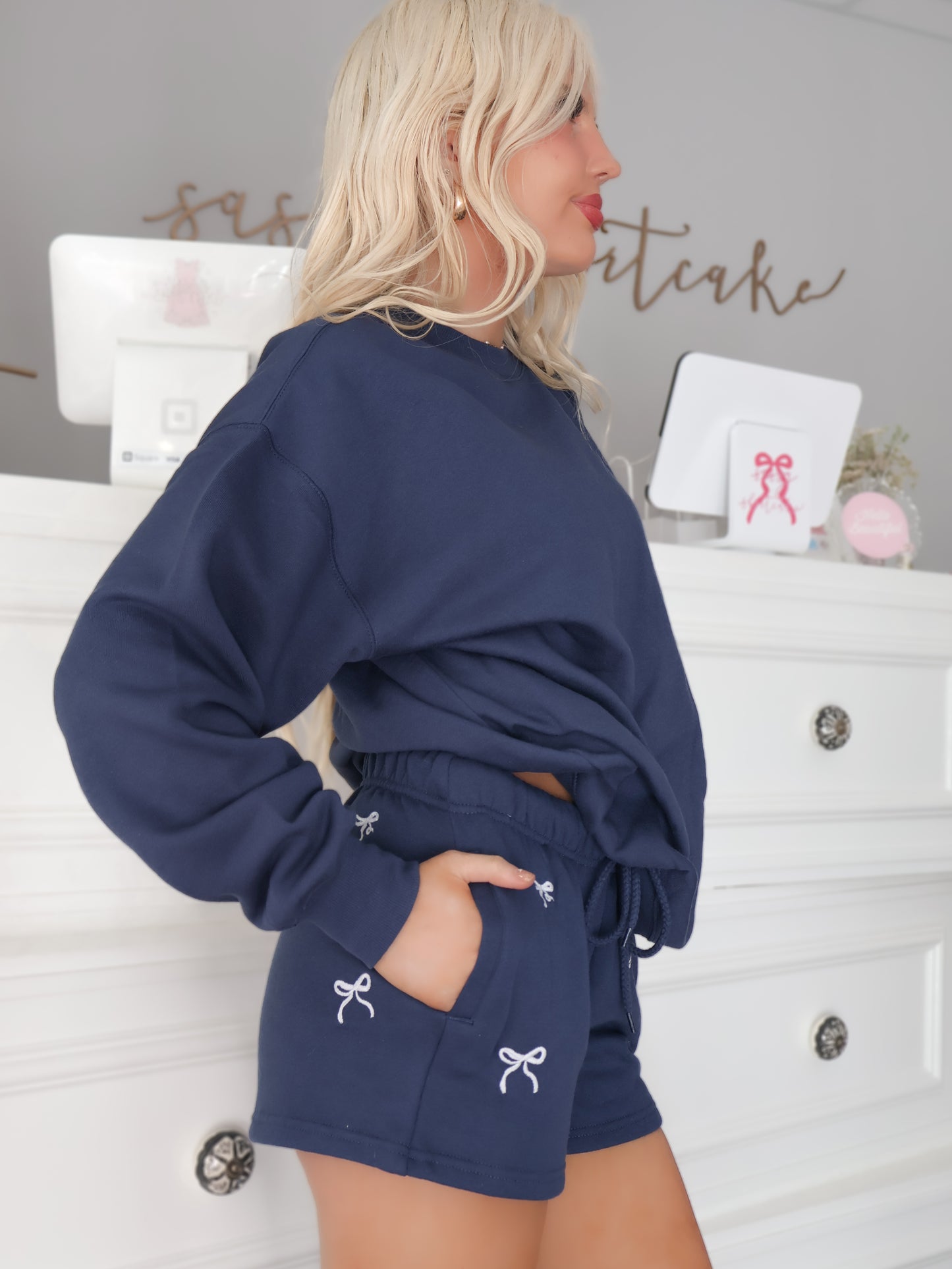 side view of sassy shortcake navy bow shorts with pockets