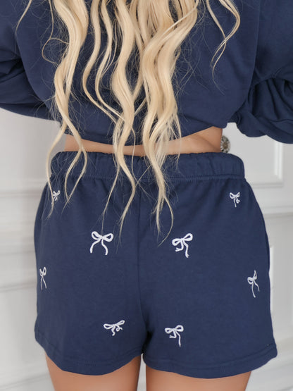 back view of sassy shortcake navy bow embroidered shorts