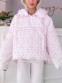 Pink quilted pullover with a delicate floral pattern, shown on a model from Sassy Shortcake