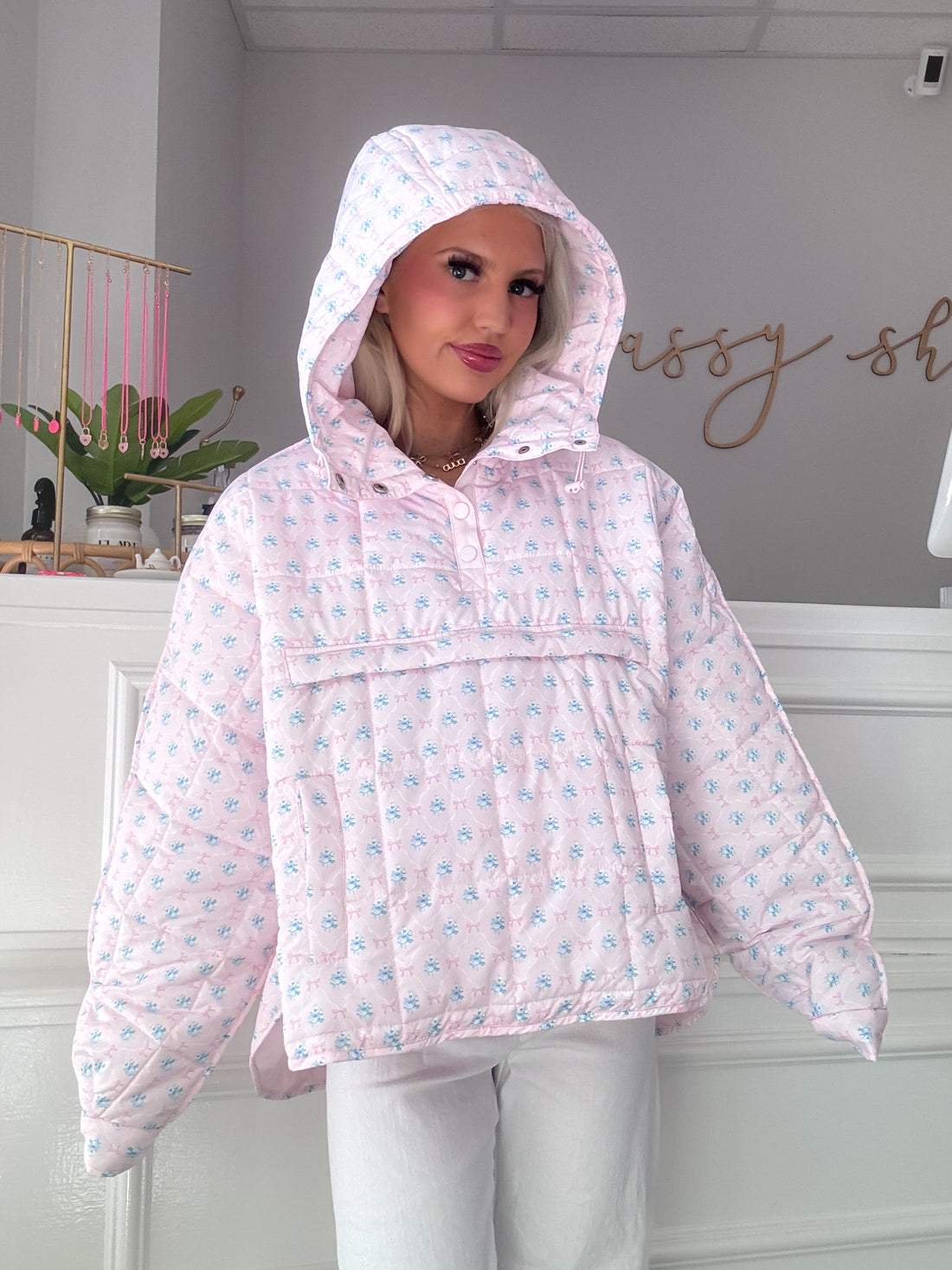 Pink quilted pullover with a floral pattern, model wearing in a boutique setting from Sassy Shortcake
