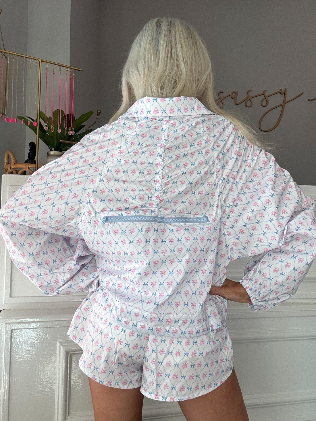 White floral windbreaker set with light blue bows, shown from the back.
