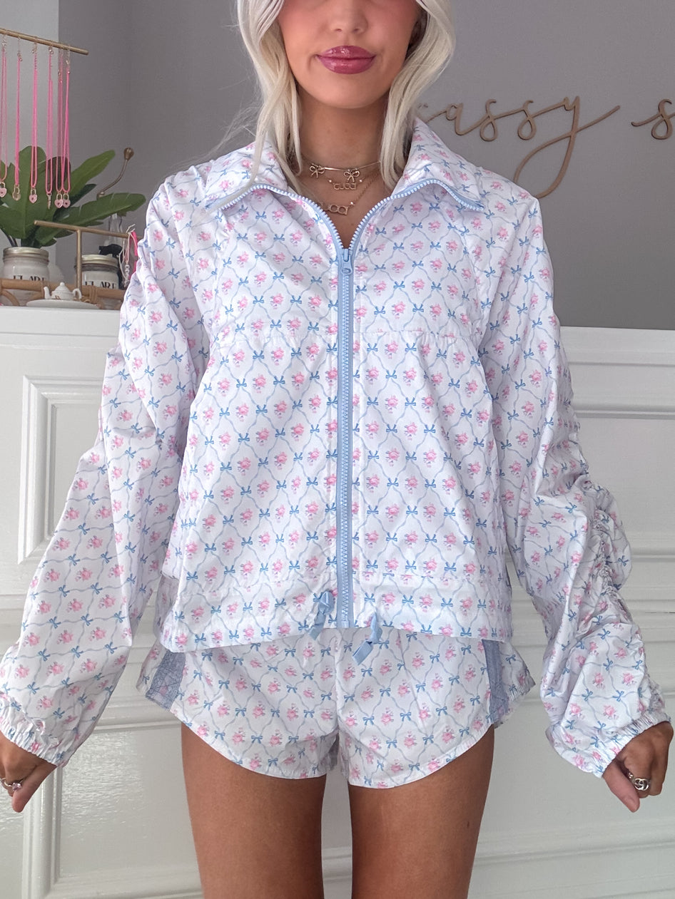 Floral-print shorts and matching jacket, light blue and pink pattern.
