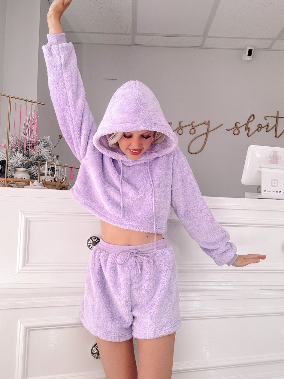Lavender plush hoodie and shorts lounge set, soft texture.
