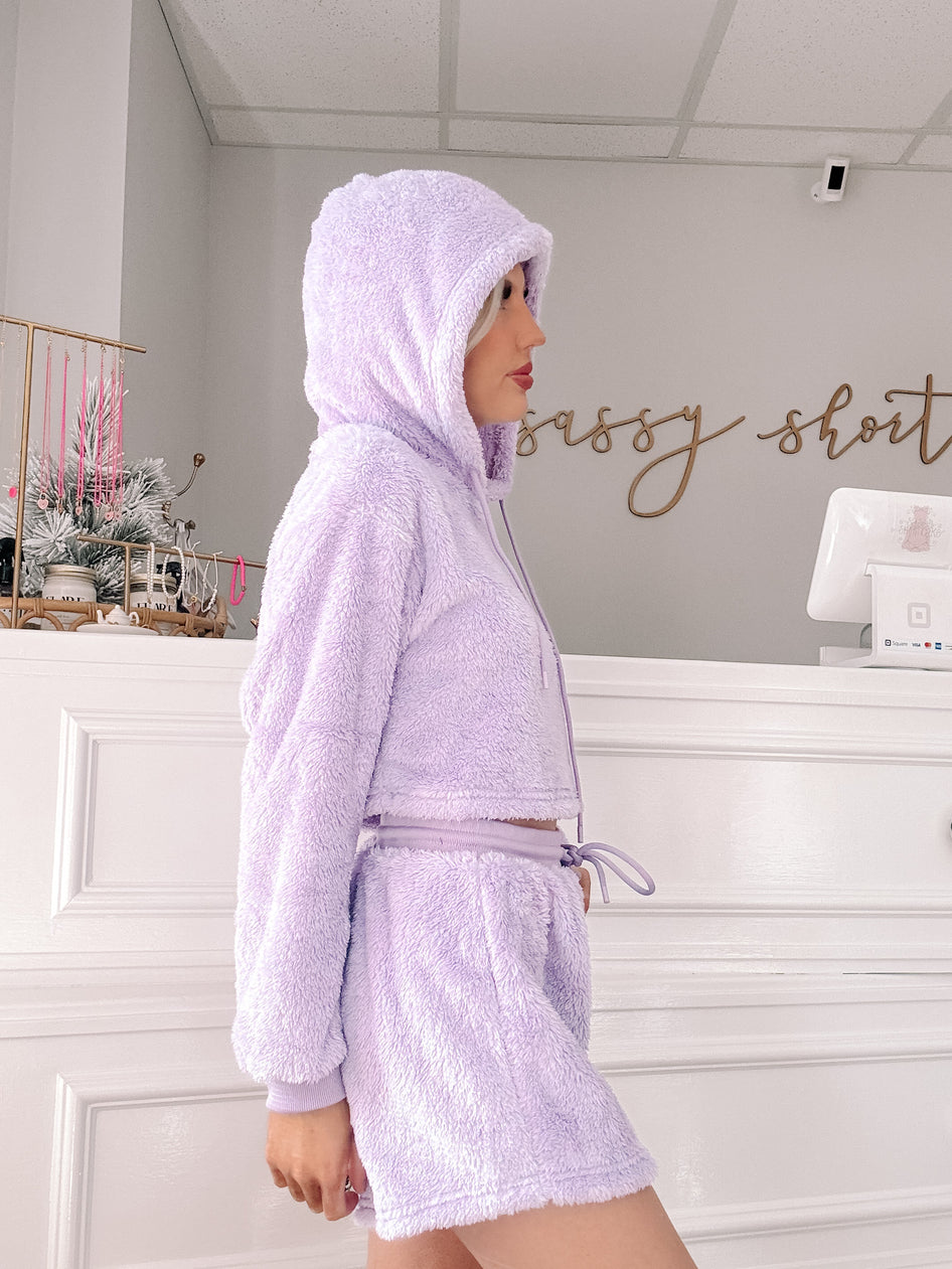 Lavender plush lounge set; cropped hoodie & shorts.
