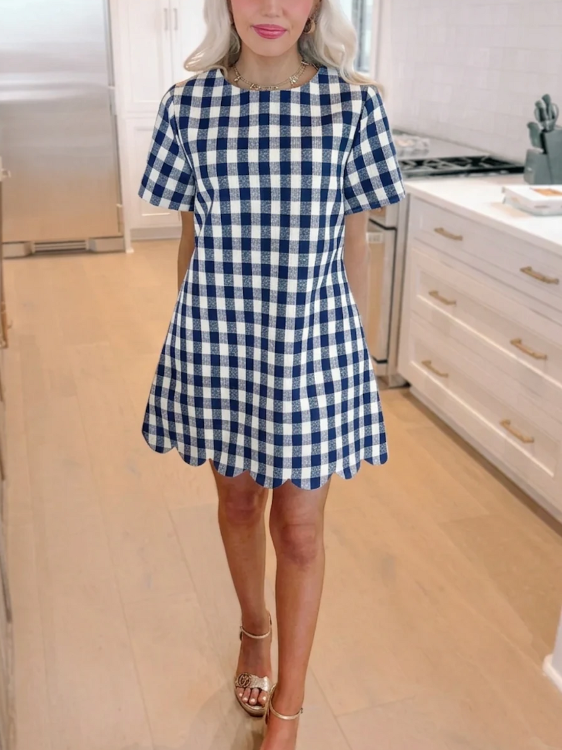 A side-angle close-up of the navy blue Picnic Princess Gingham Dress from Sassy Shortcake showing the preppy checkered fabric and classic shift fit on a blonde model.