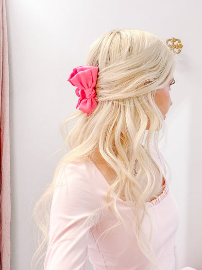 Pink Satin Bow Hair Clip by Sassy Shortcake – pink satin bow hair clip shown with other bow clips on display tray
