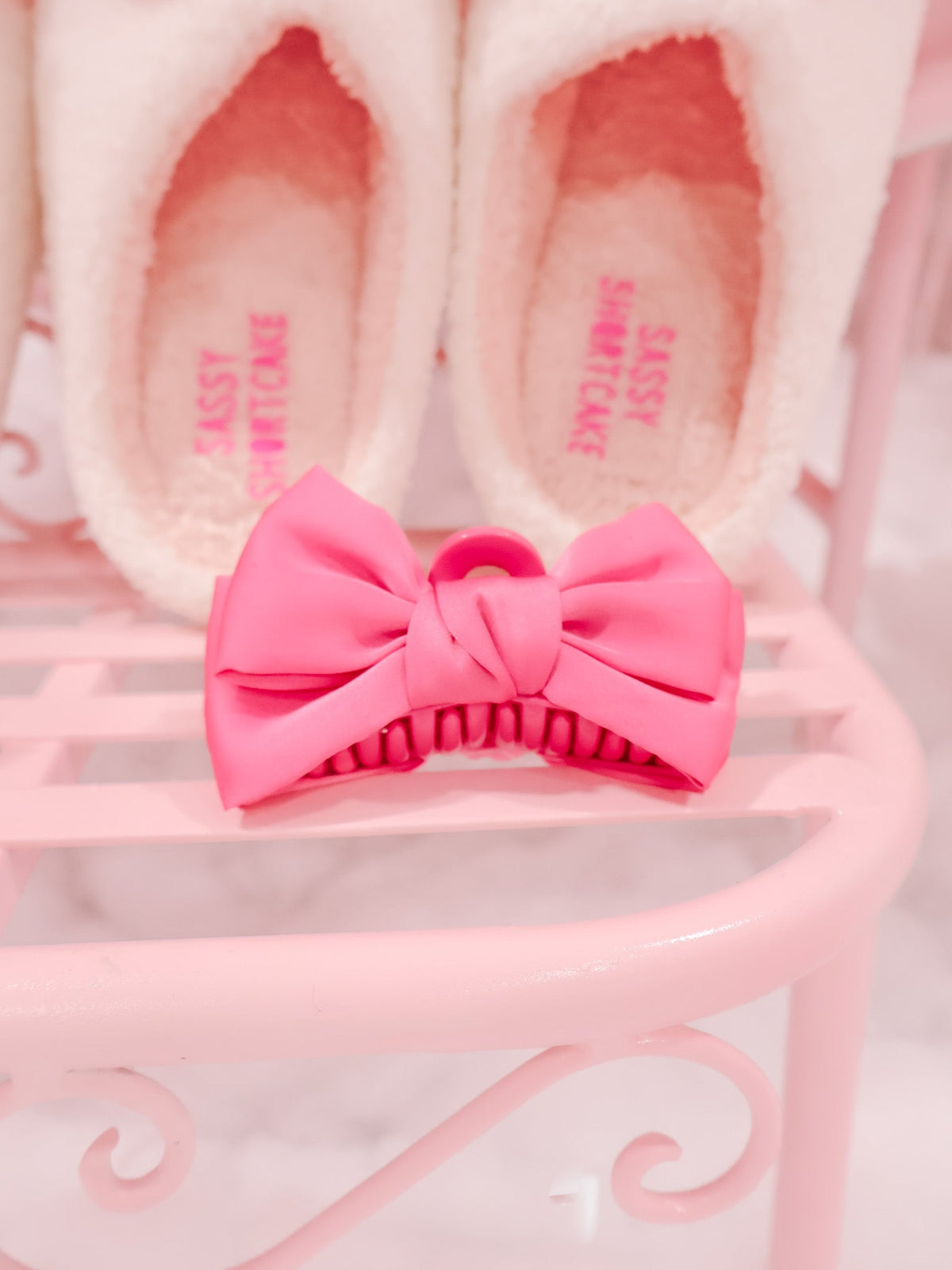 Pink Satin Bow Hair Clip Sassy Shortcake – close up pink satin bow hair accessory displayed on pink background