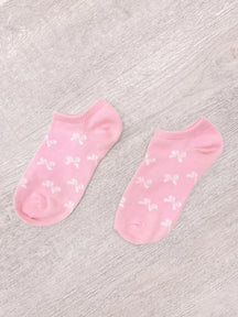 Pink bow socks with white bow pattern
