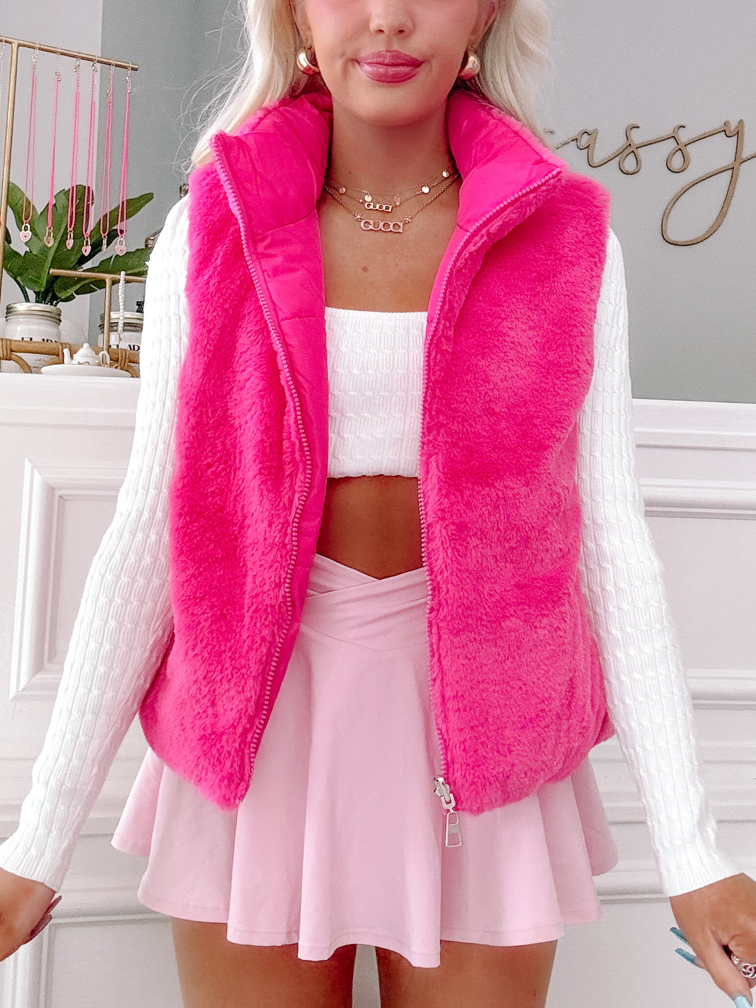 Hot pink faux fur vest styled with a white sweater and pink skirt from Sassy Shortcake 
