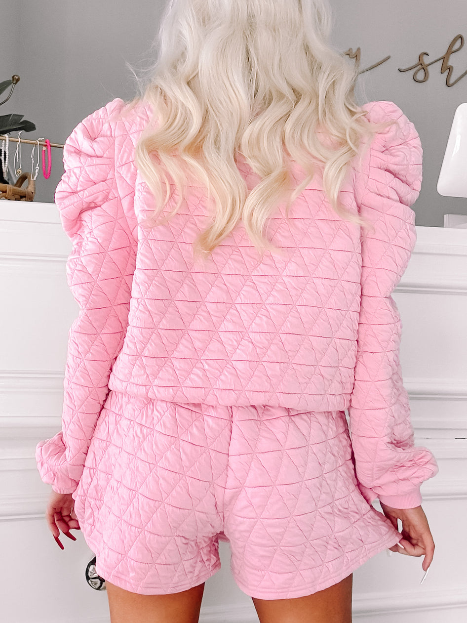 Pink quilted pajama set with puff sleeves, shown from the back.
