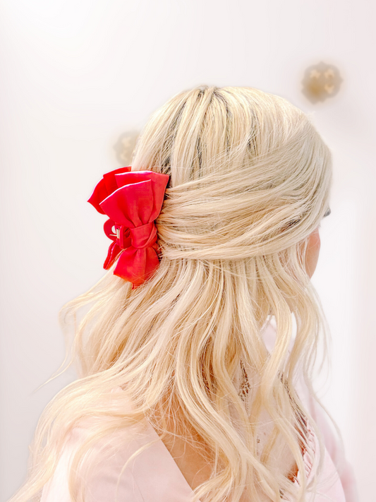 Red Satin Bow Hair Clip from Sassy Shortcake – red satin bow clipped into half-up blonde hair back view