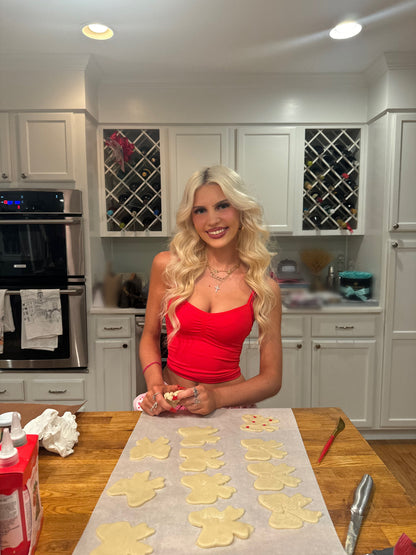 Kara Red Top by Sassy Shortcake baking in kitchen wearing ruched red fitted tank, mixing dough at counter