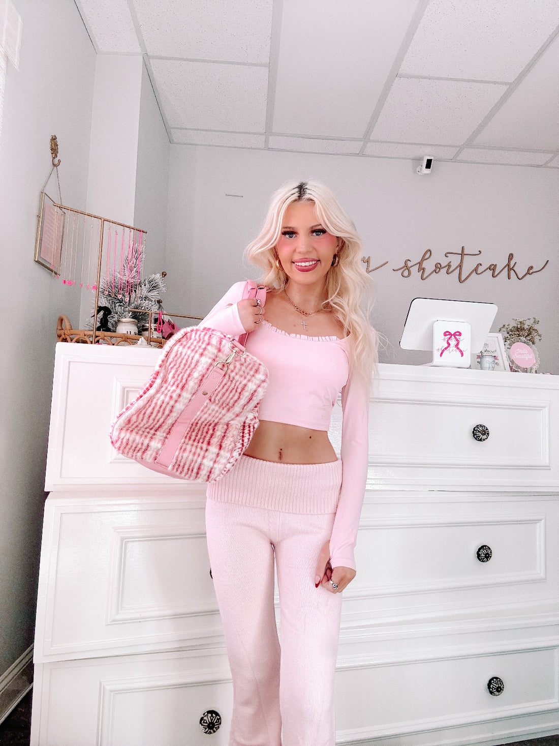 Plaid Duffel Bag by Sassy Shortcake pink plaid weekender duffel bag front view being held