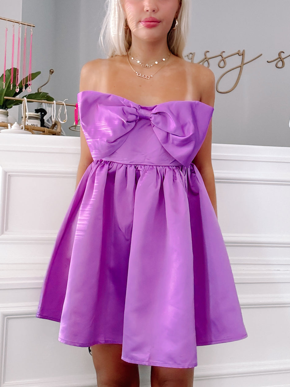 Purple Regal Ribbon Bow mini dress with satin fabric.
