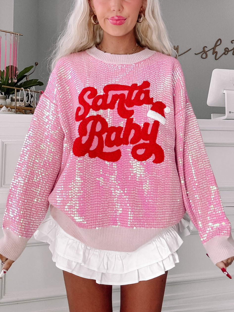 Pink sequin Santa Baby sweater with red lettering
