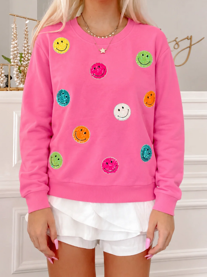 Model wearing Hot Pink Sassy Super Smiles crewneck sweatshirt with colorful glitter smiley faces from Sassy Shortcake
