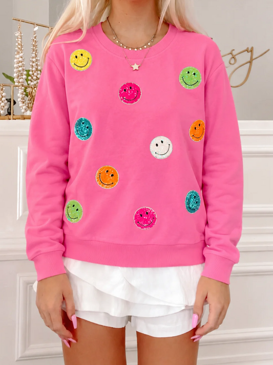 Model wearing Hot Pink Sassy Super Smiles crewneck sweatshirt with colorful glitter smiley faces from Sassy Shortcake
