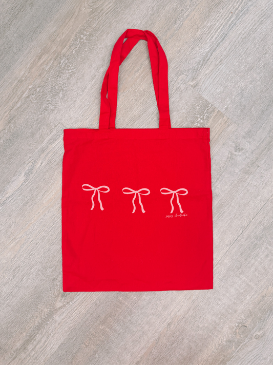 Red cotton tote bag with three pink bows and "Sassy Shortcake" text.
