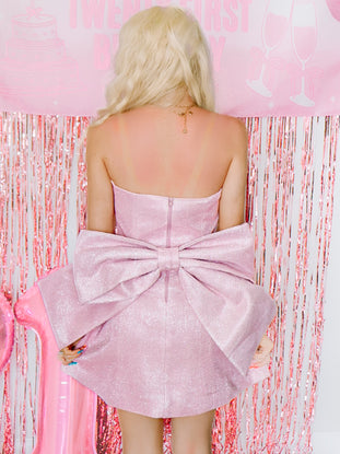 Back detail of Showstopper Dress by Sassy Shortcake, pink glitter mini dress with oversized detachable bow