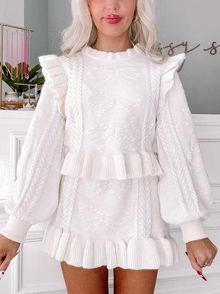 Cream cable knit sweater and skirt set with ruffle detailing
