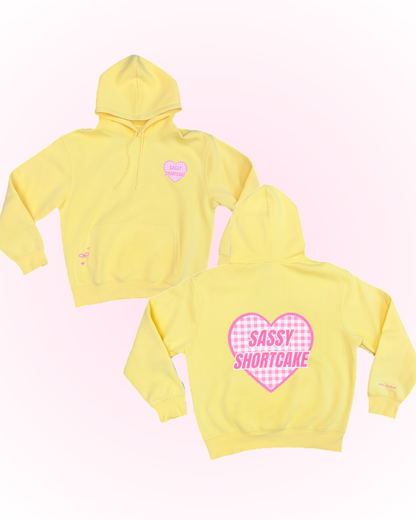 Sassy Sun Love Hoodie from Sassy Shortcake - Yellow hoodie with 'Sassy Shortcake' text on a white background