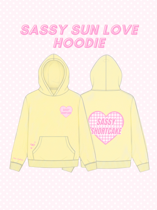 Sassy Sun Love Hoodie from Sassy Shortcake - Yellow hoodie with pink hearts and text on a light pink background