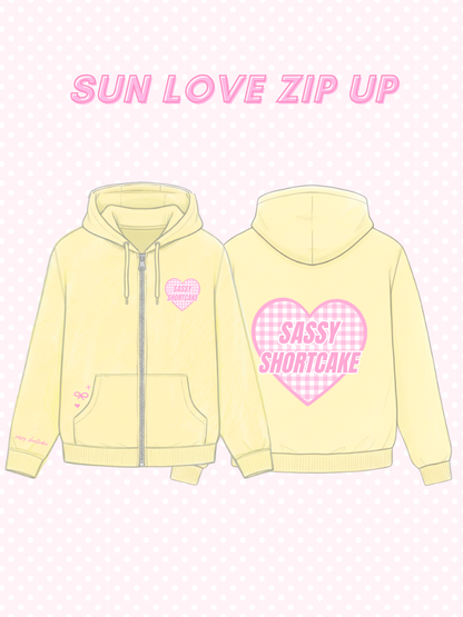 Sun Love Zip Up from Sassy Shortcake - Yellow zip-up hoodie with pink heart designs and text on a light pink background