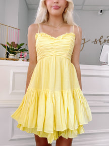 close up of yellow ruffle mini dress