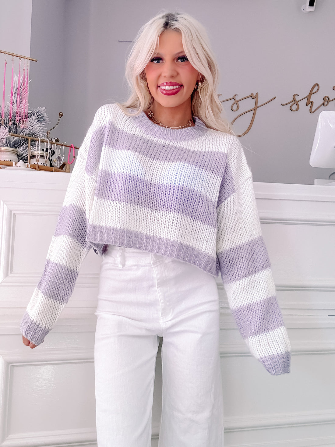 Lilac and white striped knit cropped sweater on model.
