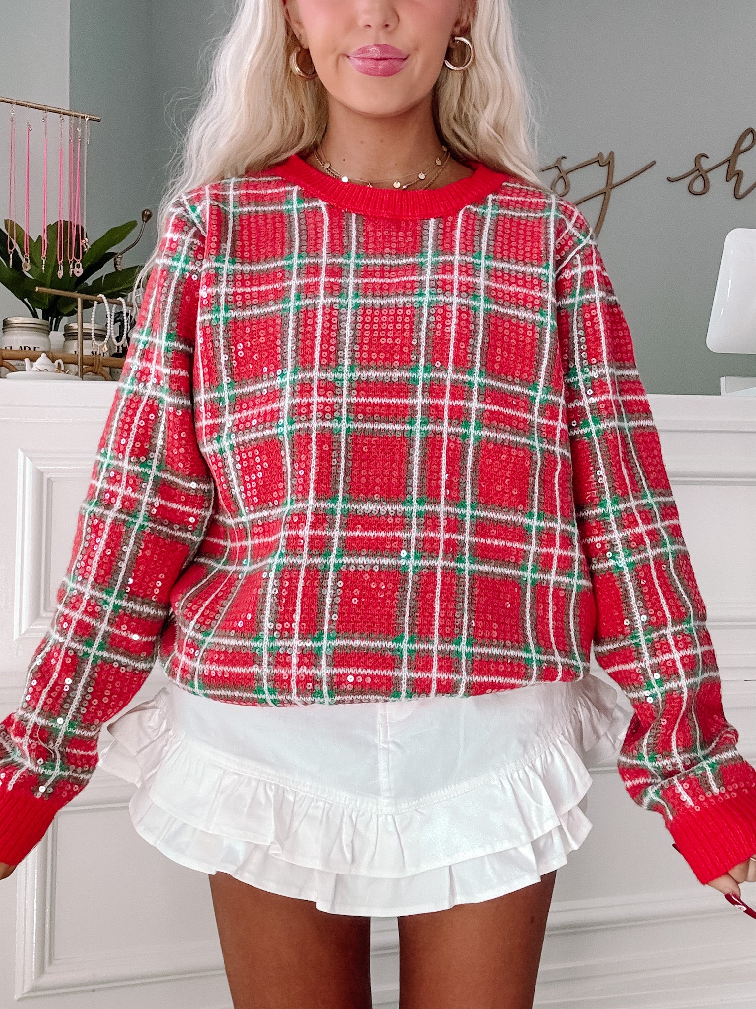 Red plaid sequin sweater – perfect for holiday gatherings. Available at Sassy Shortcake