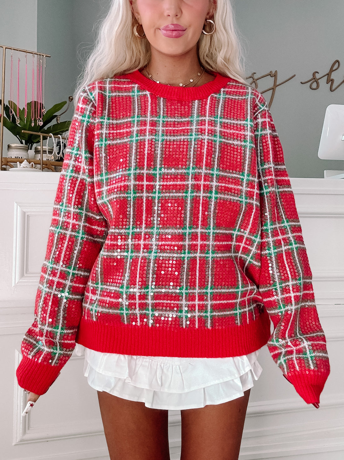 Red and green sequined plaid sweater, casual holiday style.
