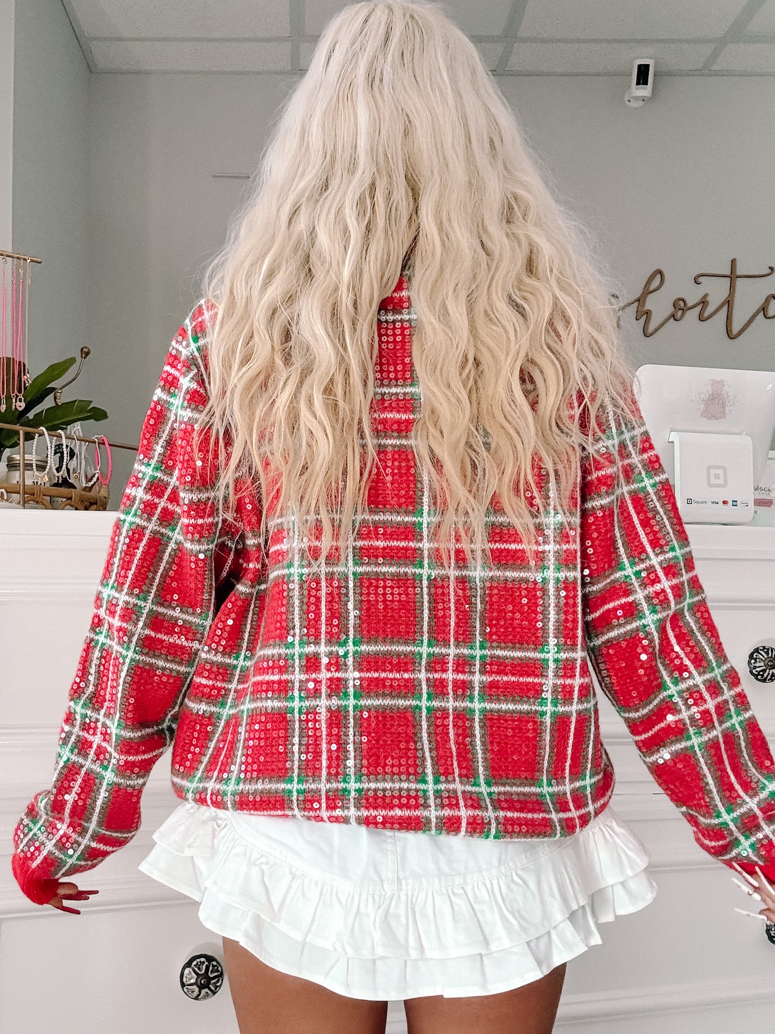 Red plaid sequin sweater – perfect for holiday gatherings. Available at Sassy Shortcake