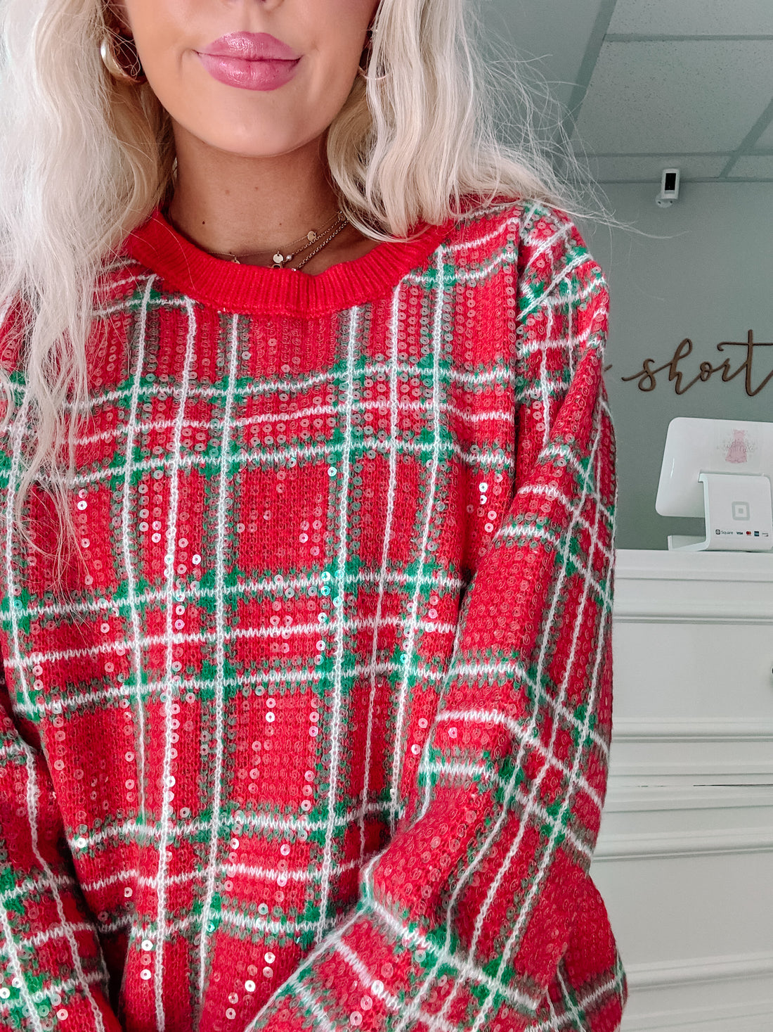 Red and green sequined plaid sweater, cozy holiday style.
