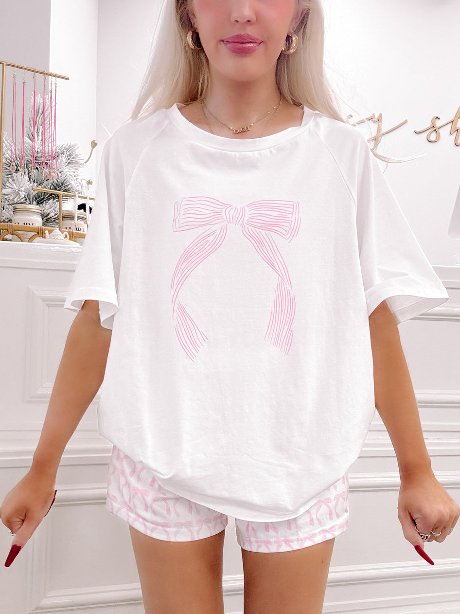 Sweet Bow Lounge Set: White oversized tee with pink bow graphic & matching pink bow print shorts.
