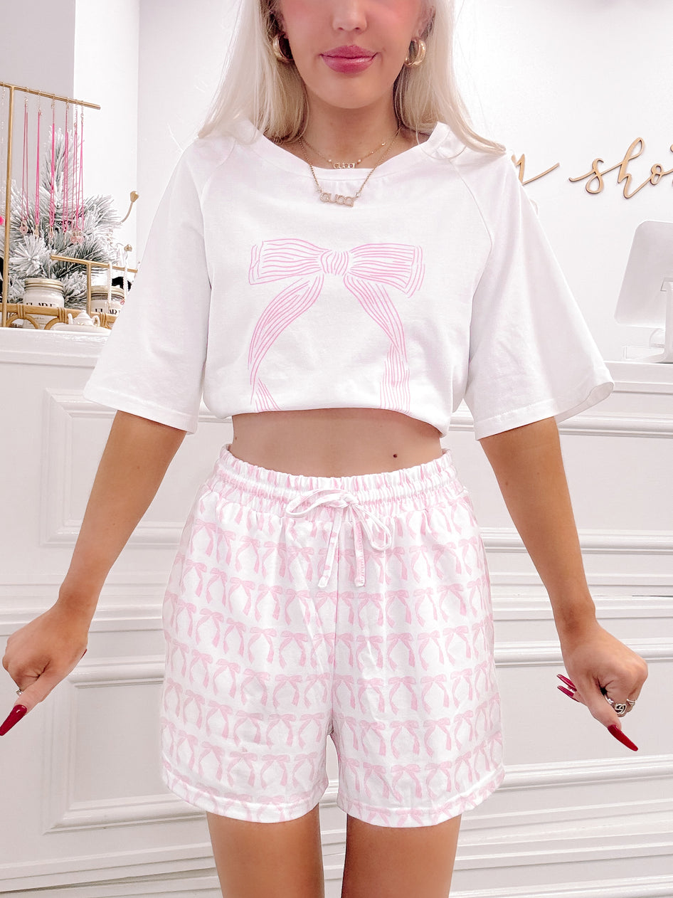 Pink bow lounge set;  cropped tee with a pink bow graphic and matching bow-print shorts.
